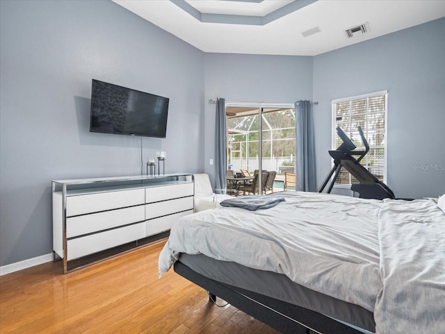 bedroom featuring light hardwood / wood-style floors and access to exterior