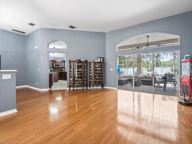 empty room with ceiling fan and hardwood / wood-style flooring