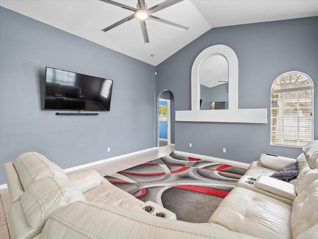 living room featuring lofted ceiling, plenty of natural light, and ceiling fan