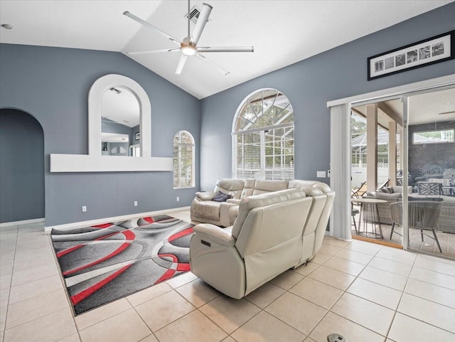 living room featuring a healthy amount of sunlight, lofted ceiling, and light tile floors