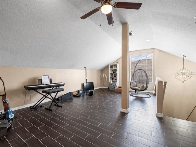 workout room with vaulted ceiling, ceiling fan, dark hardwood / wood-style flooring, and a textured ceiling