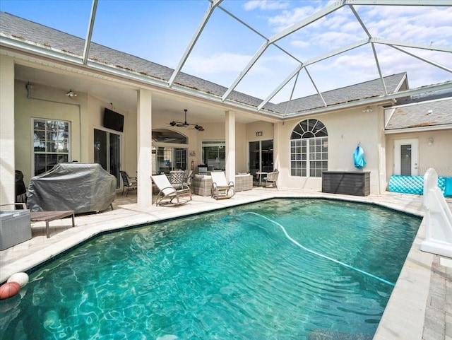 view of swimming pool featuring a patio, a lanai, ceiling fan, and an outdoor hangout area