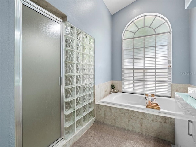 bathroom with a wealth of natural light, vanity, and independent shower and bath