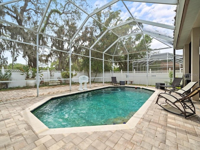 view of pool featuring a patio area and glass enclosure