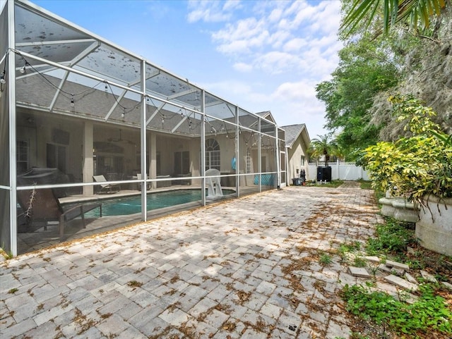 view of patio / terrace featuring a lanai