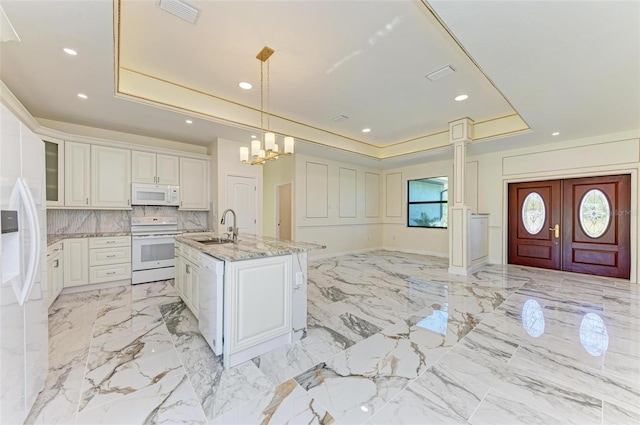 kitchen with white appliances, white cabinets, decorative light fixtures, and light stone counters