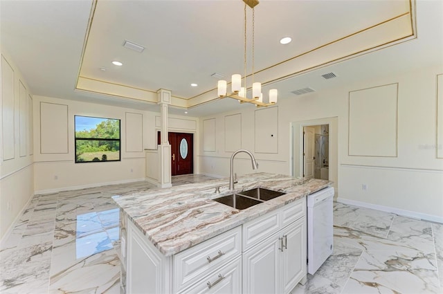 kitchen featuring white cabinets, sink, hanging light fixtures, a center island with sink, and dishwasher