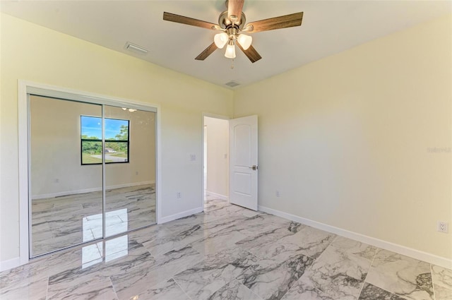 unfurnished bedroom featuring ceiling fan and a closet