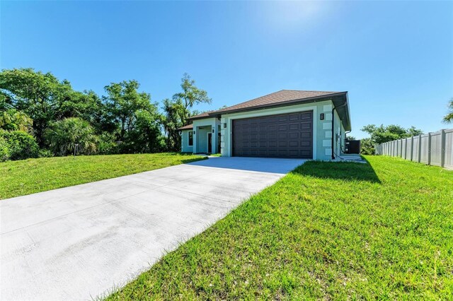 ranch-style house with a garage and a front lawn