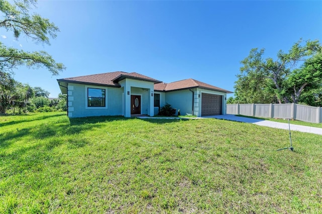 single story home with a garage and a front lawn