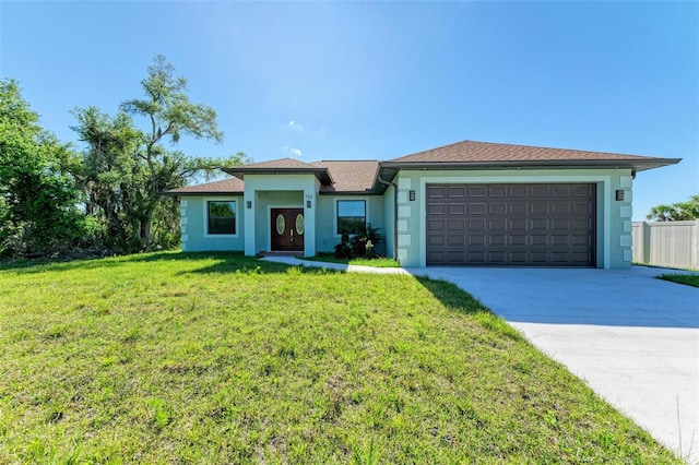 view of front of house with a front yard and a garage