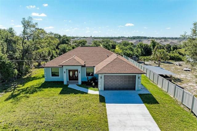 view of front of property with a garage and a front yard