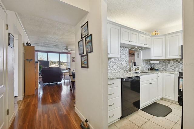 kitchen featuring white cabinets, backsplash, sink, ceiling fan, and black dishwasher