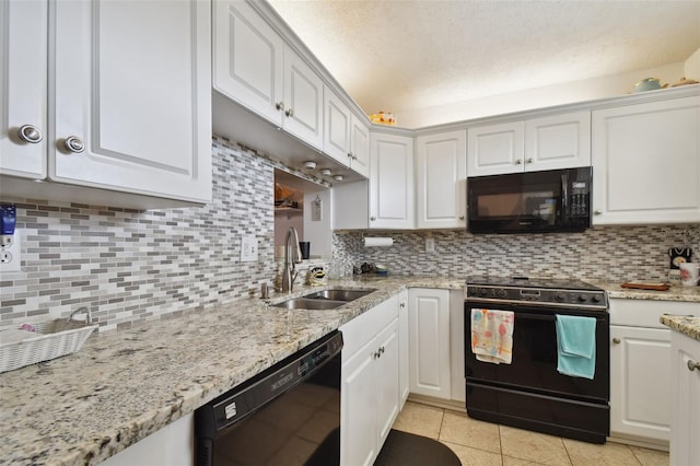 kitchen with white cabinets, backsplash, and black appliances