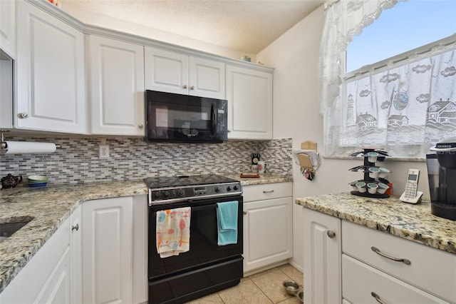 kitchen with light tile floors, tasteful backsplash, white cabinetry, and electric range oven