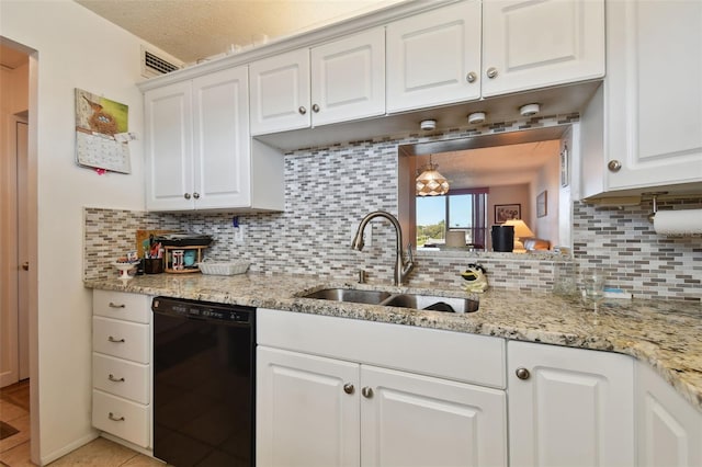 kitchen with light tile flooring, tasteful backsplash, sink, white cabinetry, and black dishwasher