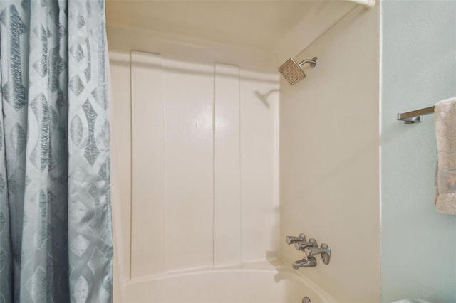 bathroom with shower / tub combo with curtain