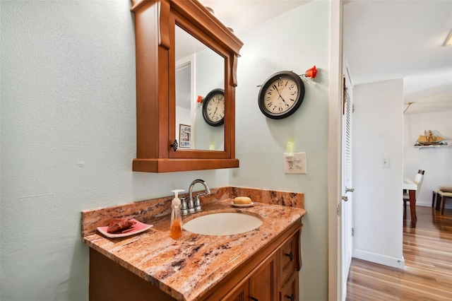 bathroom featuring vanity and hardwood / wood-style floors