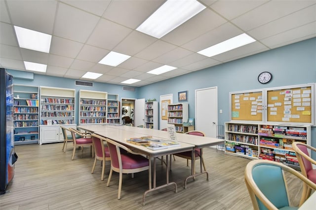 playroom featuring light hardwood / wood-style flooring and a paneled ceiling