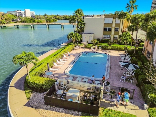 view of swimming pool with a patio and a water view