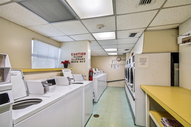 washroom featuring light tile floors and washer and clothes dryer