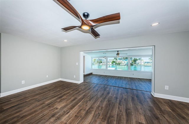 unfurnished living room with dark hardwood / wood-style floors and ceiling fan