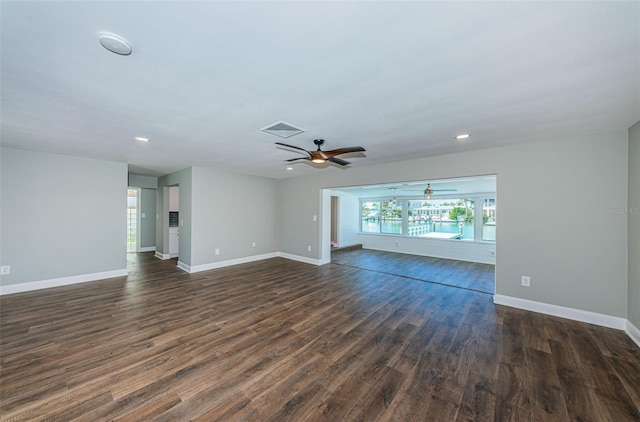 unfurnished living room with dark hardwood / wood-style floors and ceiling fan