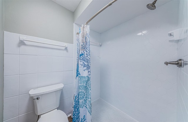 bathroom featuring toilet, walk in shower, and tile walls