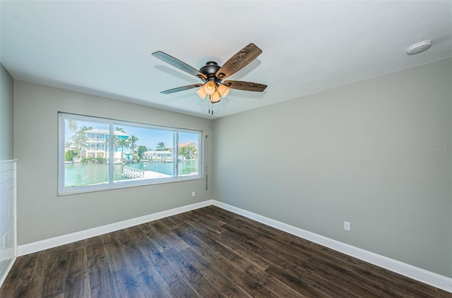 unfurnished room featuring ceiling fan and dark wood-type flooring