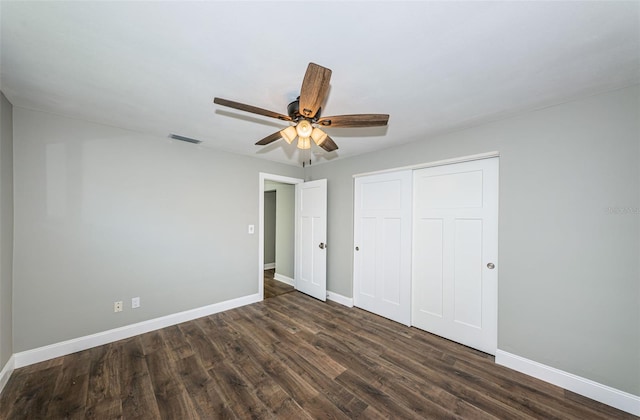 unfurnished bedroom featuring a closet, ceiling fan, and dark hardwood / wood-style flooring