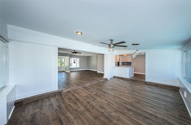 unfurnished living room with dark wood-type flooring