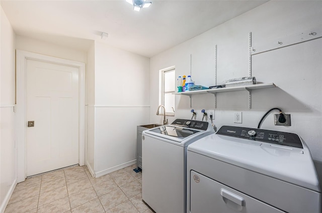 washroom with washing machine and clothes dryer and light tile patterned floors