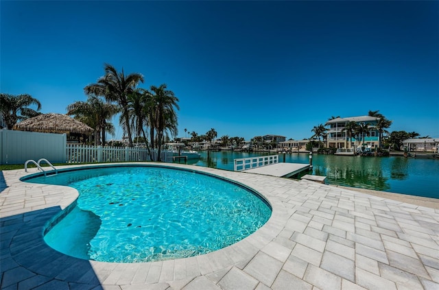 view of pool with a water view and a patio area