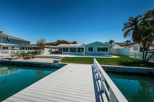 rear view of property with a fenced in pool, a yard, and a patio