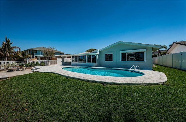 view of swimming pool featuring a patio area and a yard