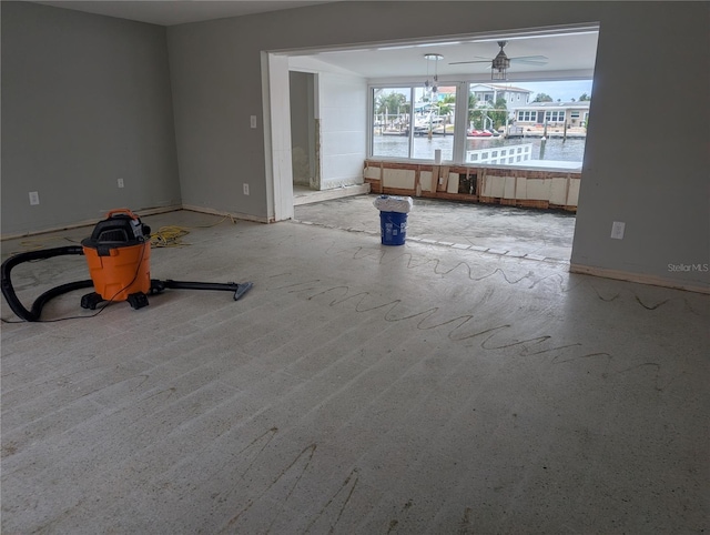 unfurnished living room with a water view