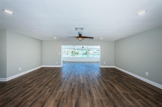 unfurnished living room featuring dark hardwood / wood-style flooring and ceiling fan