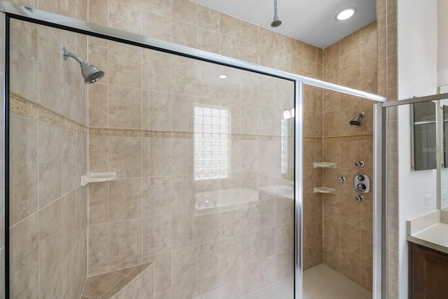 bathroom with vanity and a shower with shower door