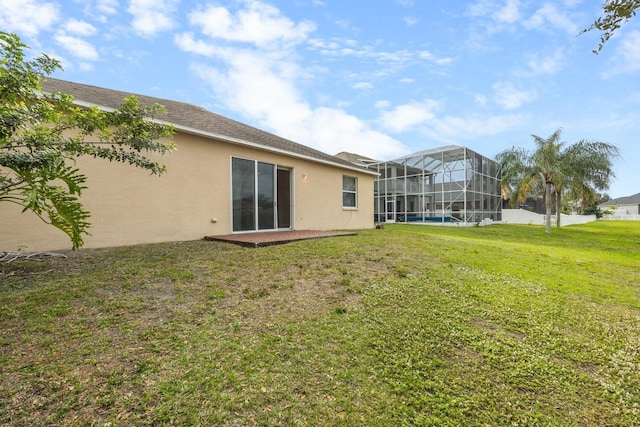 rear view of property with a lawn