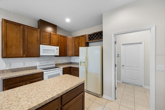 kitchen with backsplash, white appliances, and light tile patterned floors