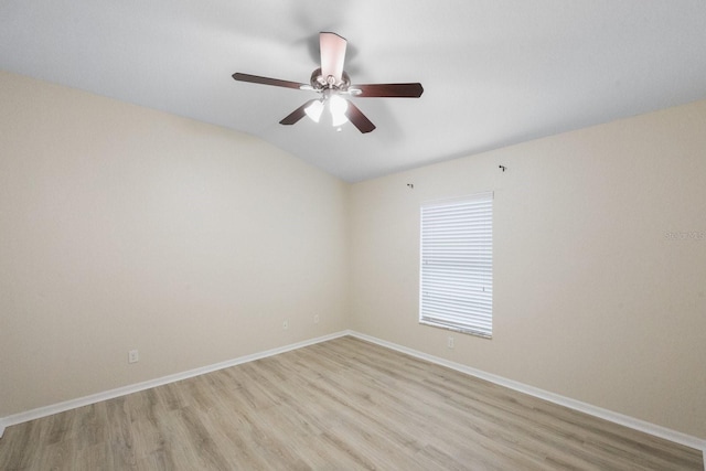 empty room with ceiling fan, lofted ceiling, and light wood-type flooring