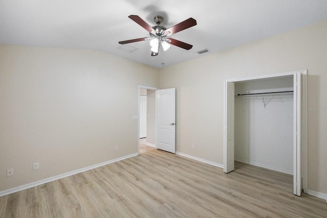 unfurnished bedroom featuring light hardwood / wood-style flooring, a closet, and ceiling fan