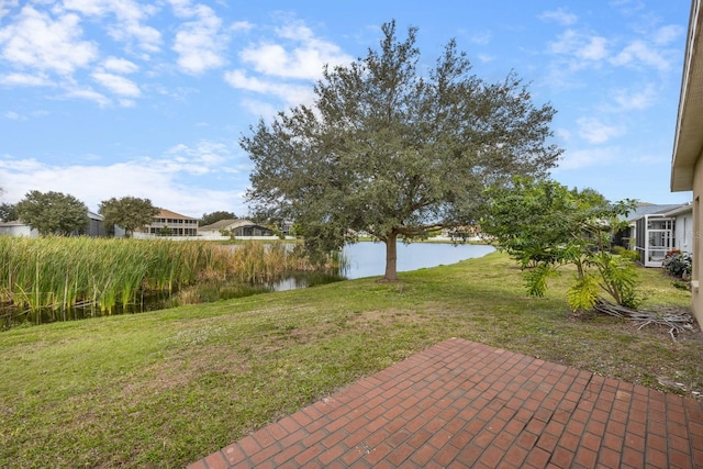 view of yard featuring a patio and a water view