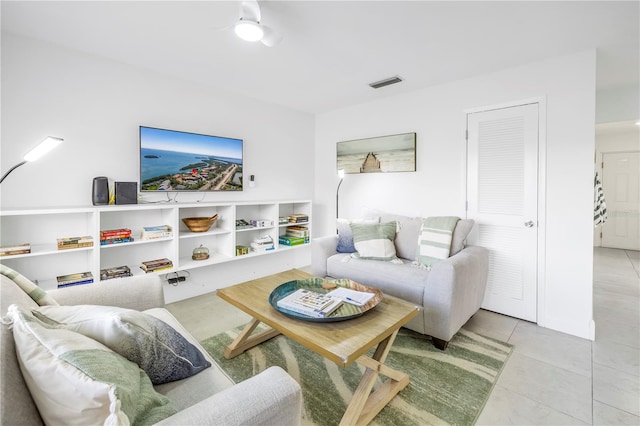 tiled living room with ceiling fan