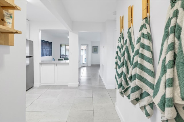 hallway featuring light tile flooring