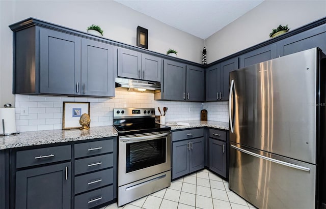 kitchen with decorative backsplash, stainless steel appliances, light stone countertops, and light tile patterned flooring