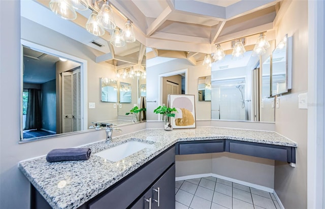 bathroom featuring tile patterned flooring, vanity, and walk in shower