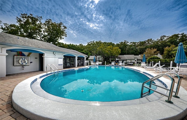 view of swimming pool with a patio