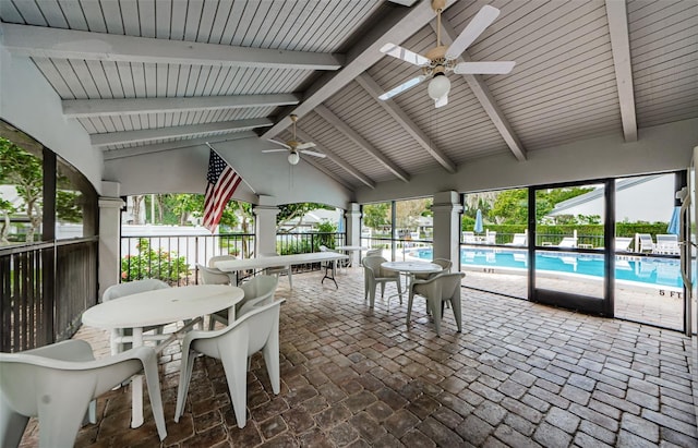 exterior space featuring lofted ceiling with beams, a pool, and ceiling fan