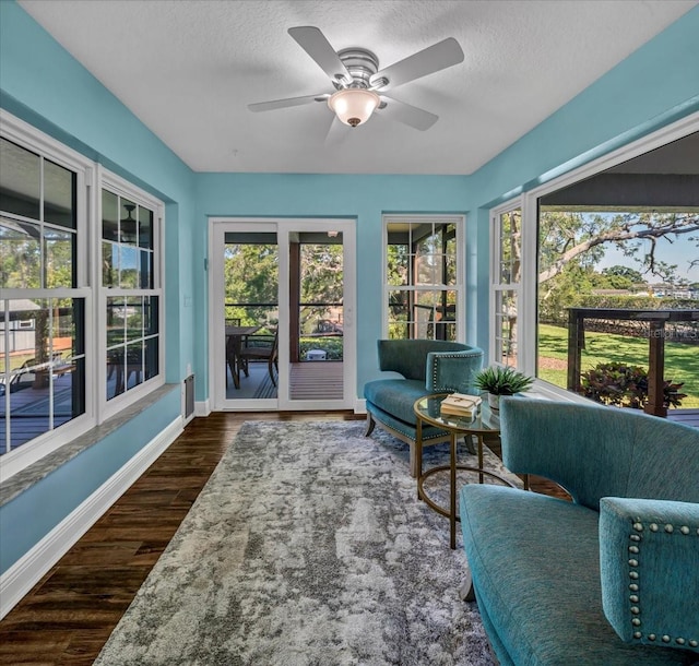 sunroom / solarium featuring ceiling fan